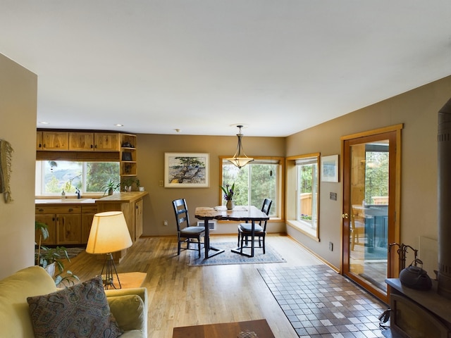 dining room featuring sink and light hardwood / wood-style flooring