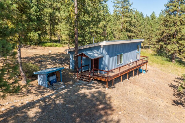 back of house featuring a deck