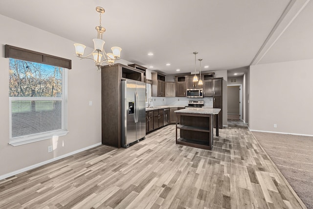 906 Valley Ave, Chewelah, WA 99109 - kitchen featuring open shelves, appliances with stainless steel finishes, baseboards, and an inviting chandelier