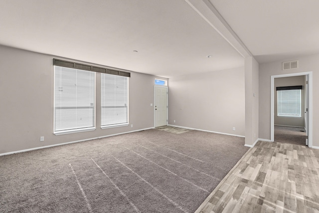 906 Valley Ave, Chewelah, WA 99109 - unfurnished room with baseboards, visible vents, a healthy amount of sunlight, and wood finished floors
