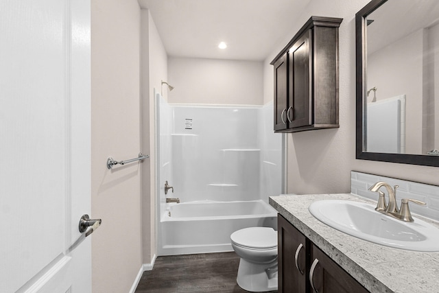 906 Valley Ave, Chewelah, WA 99109 - bathroom featuring wood finished floors, baseboards, vanity, toilet, and bathing tub / shower combination