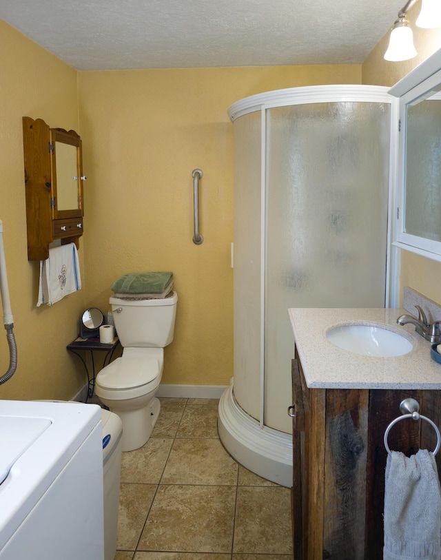 1239 Kewa Meteor Rd, Inchelium, WA 99138 - bathroom with vanity, a stall shower, tile patterned floors, and washer / dryer