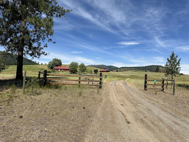 1239 Kewa Meteor Rd, Inchelium, WA 99138 - view of dirt / gravel driveway with a view of rural / pastoral area, a mountain view, and a gated entry