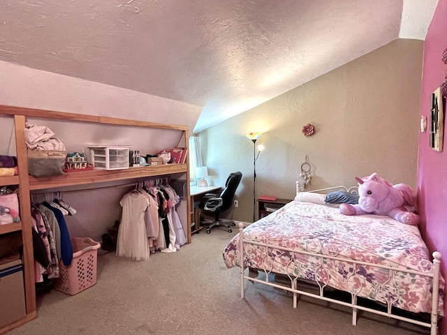 bedroom featuring vaulted ceiling, carpet flooring, and a textured ceiling