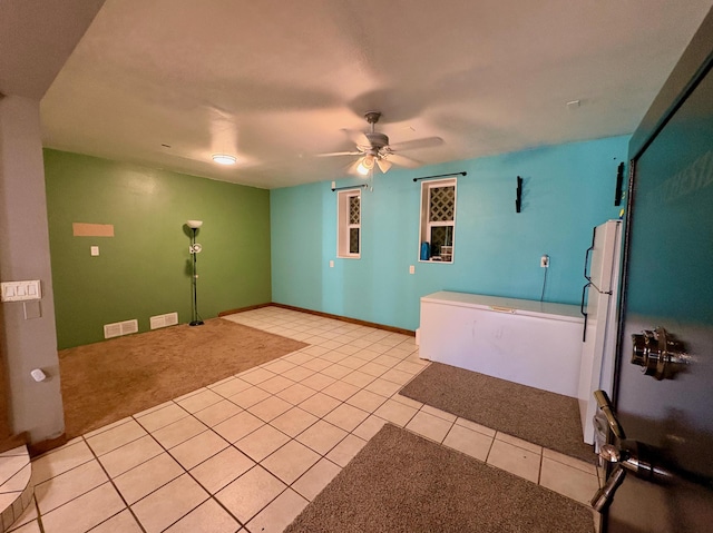 interior space featuring ceiling fan and tile patterned floors