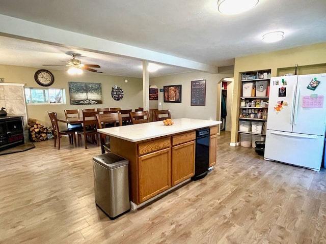 kitchen featuring light wood-type flooring, a center island, ceiling fan, and white fridge