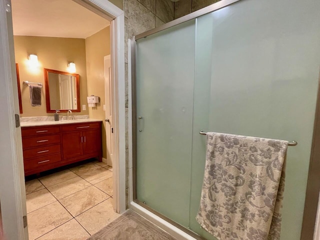 bathroom with vanity, walk in shower, and tile patterned flooring