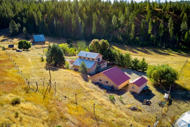 bird's eye view featuring a rural view and a wooded view