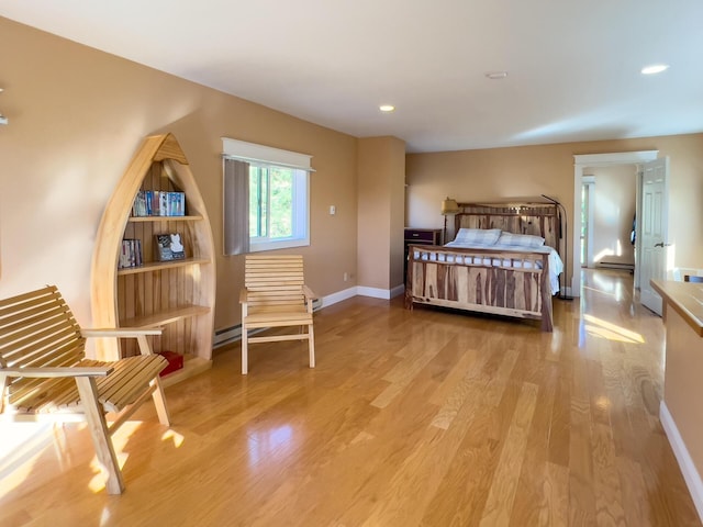 bedroom with recessed lighting, wood finished floors, and baseboards