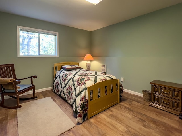 bedroom with hardwood / wood-style floors