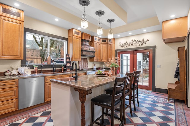 kitchen featuring a kitchen breakfast bar, dishwasher, french doors, dark stone counters, and a kitchen island with sink