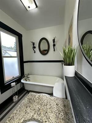 bathroom featuring a tub to relax in and vanity