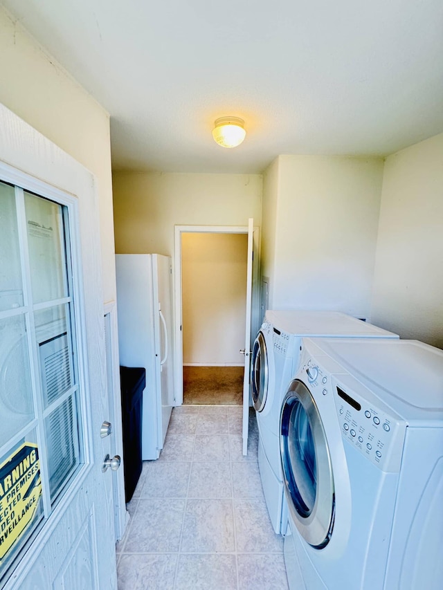 211 8th Ave, Ione, WA 99139 - washroom featuring washing machine and clothes dryer and light tile patterned floors