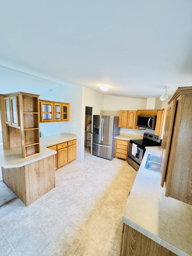 211 8th Ave, Ione, WA 99139 - kitchen featuring appliances with stainless steel finishes, light countertops, a peninsula, and glass insert cabinets