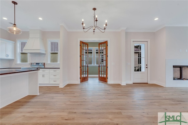 49 Salt Marsh Dr, Midway, GA 31320 - kitchen with white cabinets, hanging light fixtures, light hardwood / wood-style floors, and an inviting chandelier
