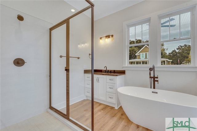 49 Salt Marsh Dr, Midway, GA 31320 - bathroom with wood-type flooring, vanity, and independent shower and bath