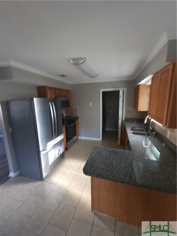 kitchen featuring appliances with stainless steel finishes, crown molding, light tile floors, kitchen peninsula, and sink