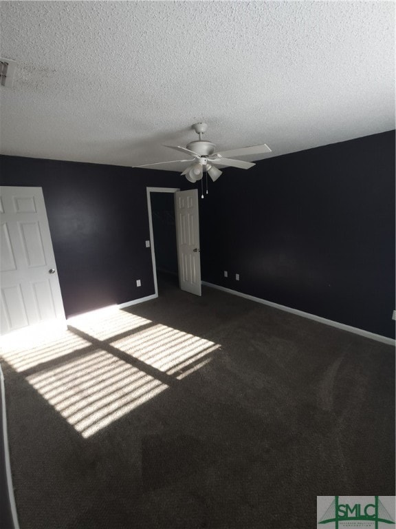 carpeted spare room with ceiling fan and a textured ceiling