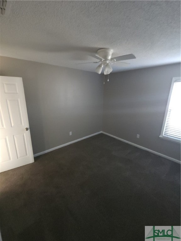 carpeted spare room with ceiling fan and a textured ceiling