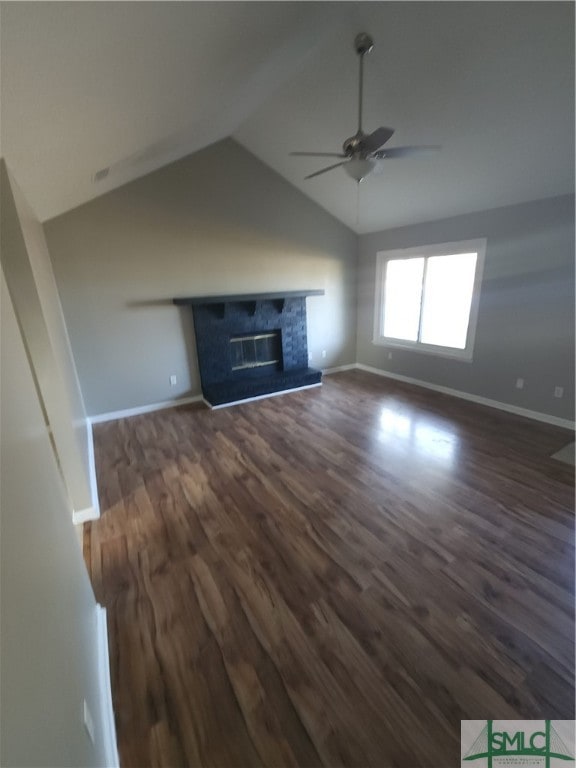 unfurnished living room with ceiling fan, dark hardwood / wood-style floors, and vaulted ceiling