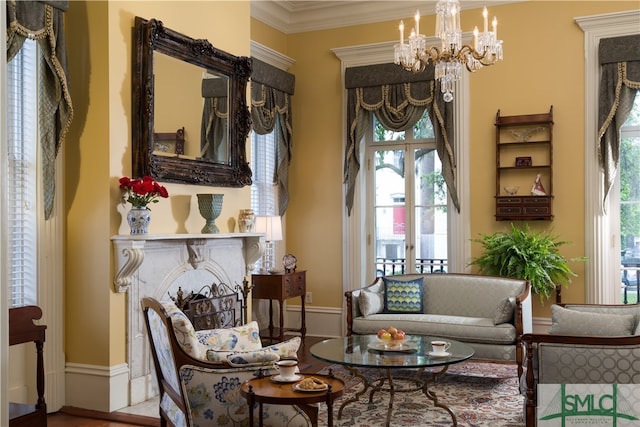 living area featuring hardwood / wood-style flooring, an inviting chandelier, and ornamental molding