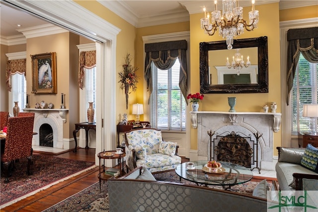 sitting room with hardwood / wood-style floors, an inviting chandelier, and crown molding