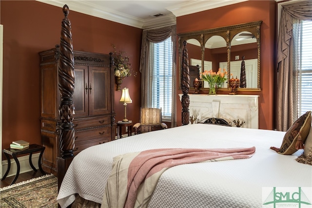 bedroom with hardwood / wood-style floors and ornamental molding