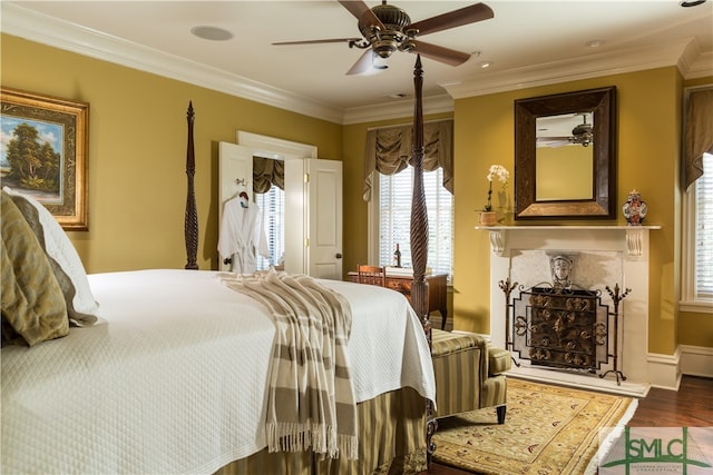 bedroom with ceiling fan, dark hardwood / wood-style flooring, and ornamental molding