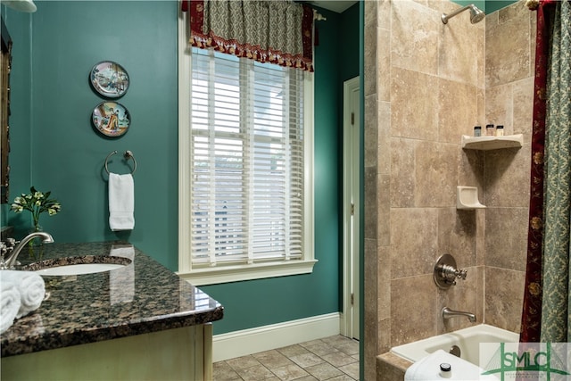 bathroom with vanity and tiled shower / bath