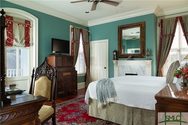 bedroom with hardwood / wood-style flooring, ceiling fan, and multiple windows