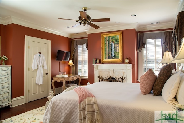 bedroom with ceiling fan, crown molding, dark wood-type flooring, and multiple windows