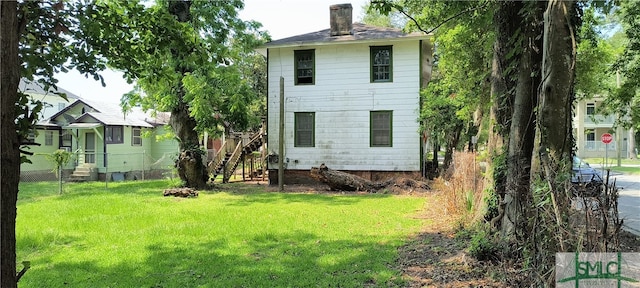 back of property with a yard