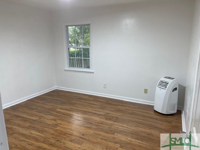 unfurnished room with dark hardwood / wood-style floors