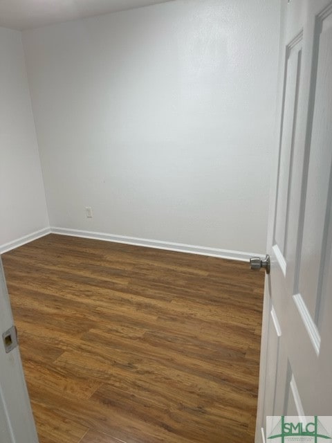 spare room featuring dark wood-type flooring