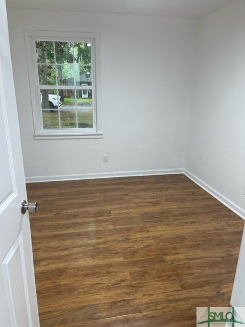 empty room with dark wood-type flooring