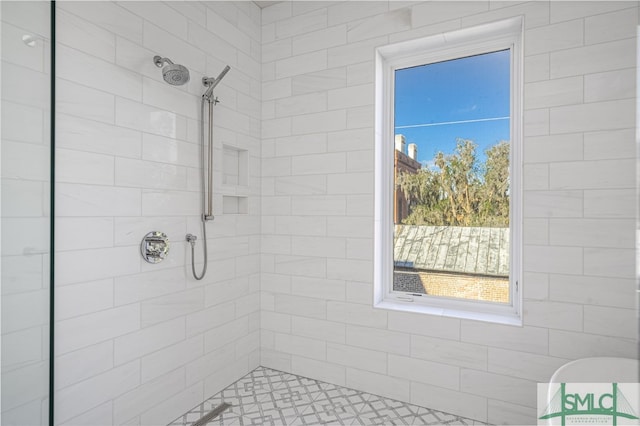 bathroom with tiled shower