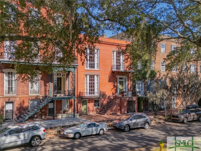 view of front of property with brick siding and stairs