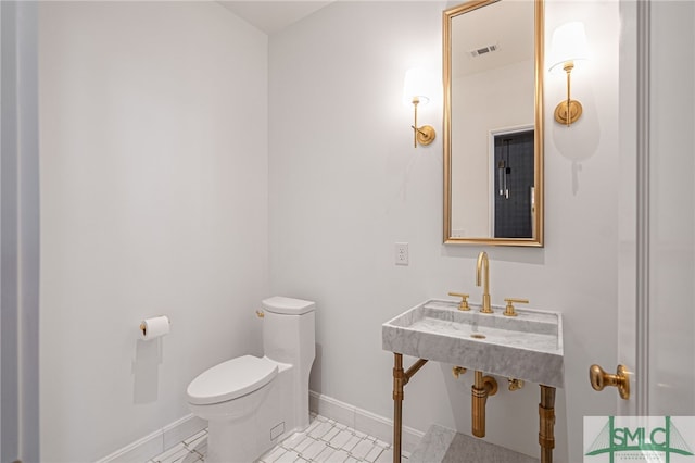 bathroom with tile patterned flooring and toilet