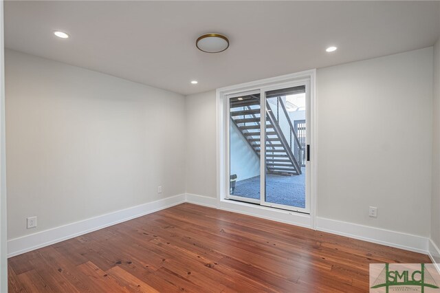 spare room with hardwood / wood-style flooring