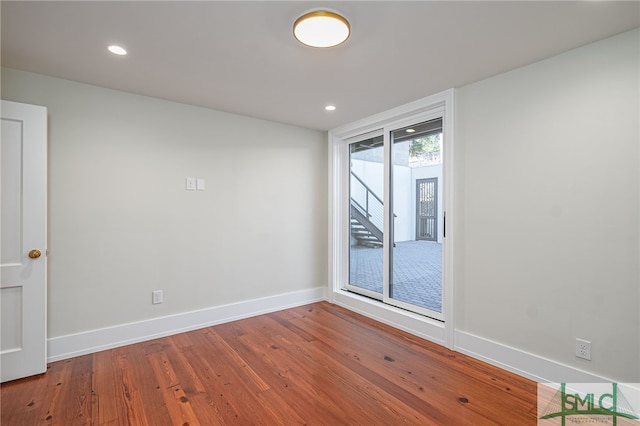 unfurnished room with hardwood / wood-style floors