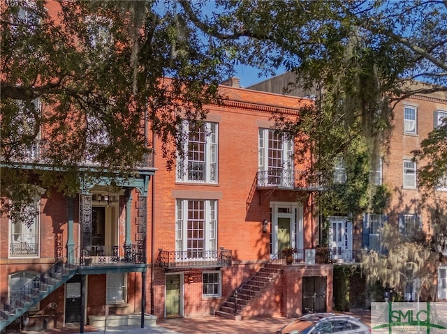 multi unit property with stairs and brick siding