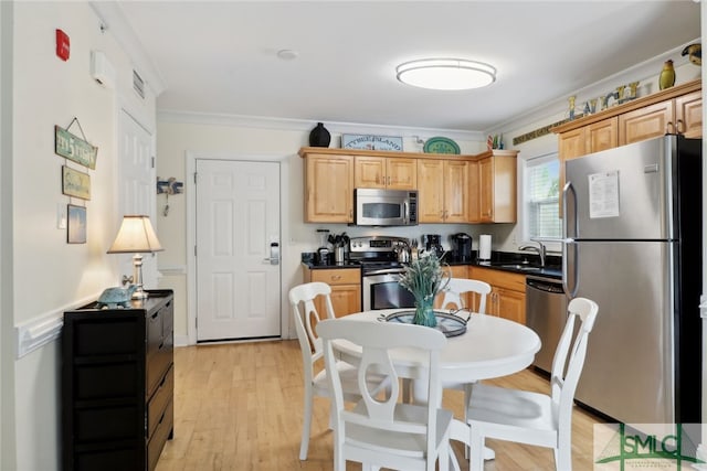 kitchen with appliances with stainless steel finishes, light brown cabinetry, light hardwood / wood-style floors, sink, and crown molding