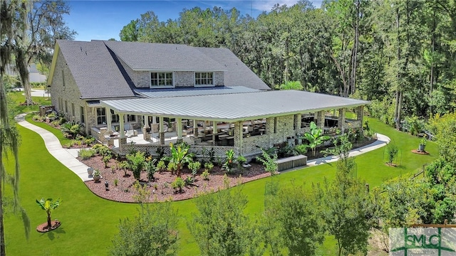 rear view of property with a yard