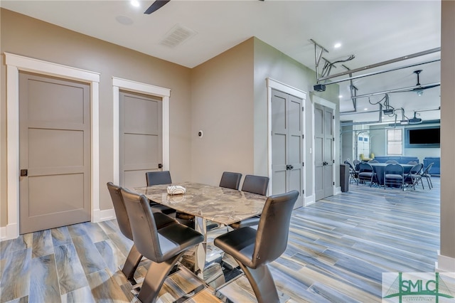 dining room with light hardwood / wood-style floors and ceiling fan