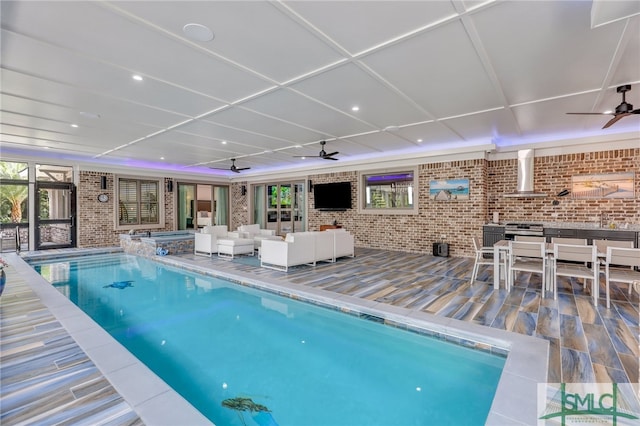 view of swimming pool with ceiling fan, an outdoor living space, and a patio