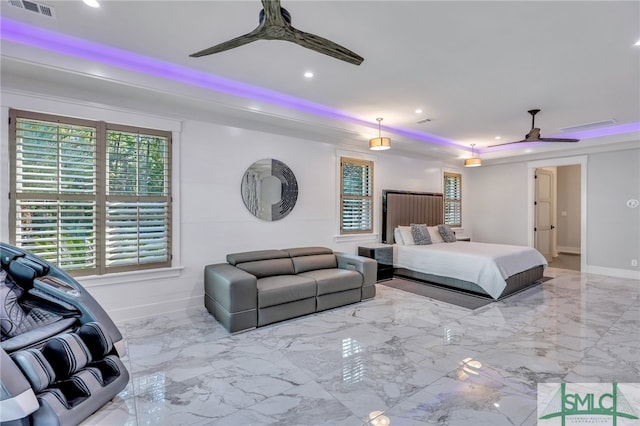 bedroom with ceiling fan, light tile floors, and a tray ceiling