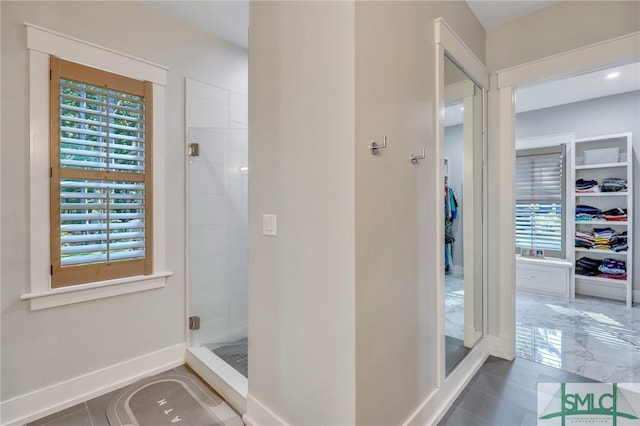 bathroom with tile floors, an enclosed shower, and a wealth of natural light