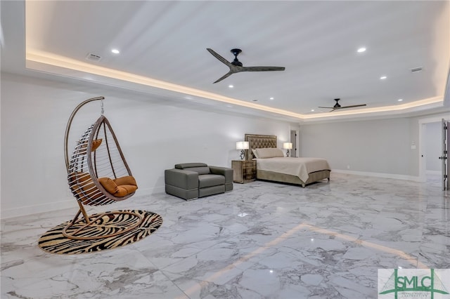 unfurnished living room with light tile flooring, a tray ceiling, and ceiling fan