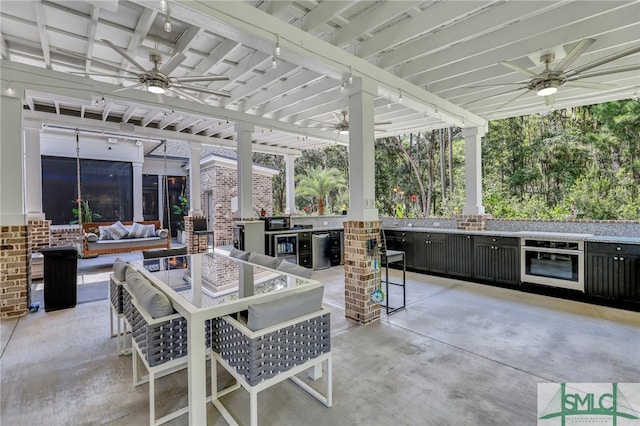 view of patio / terrace with ceiling fan, area for grilling, and an outdoor living space