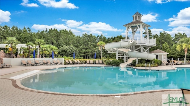 view of pool featuring a patio and a water slide